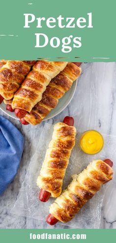 two sausages with ketchup and mustard are on the table next to each other