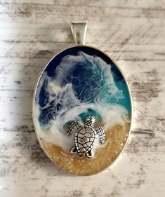 a sea turtle swimming in the ocean on a white marble counter top with waves crashing behind it