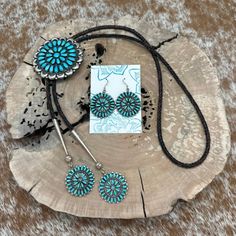 Embrace Southwest elegance with this exquisite one-of-a-kind bolo tie and earrings set, put together by a skilled silversmith and jewelry designer from the Chicago area. The bolo slide, repurposed from a 1960s era Navajo round cluster pin adorned with teardrop-shaped turquoise stones, showcases a captivating 10-petal flower design with crescent-shaped and raindrop accents around its border. The chocolate brown and black cording complements the slide beautifully, while the tips feature 8mm bench Bolo Ties, Petal Flower, Navajo Turquoise, Bolo Tie, Southwest Style, Turquoise Stones, Tie Accessories, Jewelry Designer, Schmuck Design