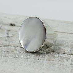 "Elegant white Mother of pearl round ring set on 925 sterling silver with a gorgeous genuine white mop cap quality jewelry solid quality work Dimensions Length x Width : 26 x 26 mm Weight 12.3 grams Colors : WHITE PEARL MOP RING SIZING is available if you need a bigger or smaller size choose option \"Ring + Resizing\" and put option in message box.  For resizing it takes 5 to 7 days before shipping / $20 usd done by laser" Luxury White Signet Ring With Polished Finish, Luxury White Moonstone Ring, Luxury White Moonstone Ring With Polished Finish, Luxury White Polished Moonstone Ring, White Polished Signet Ring For Formal Occasions, White Round Dome Ring For Anniversary, Formal White Signet Ring With Polished Finish, Minimalist White Dome Ring, Polished Mother Of Pearl Jewelry For Formal Occasions