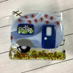 a glass plate with a camper and flowers on it