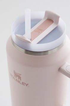 a pink coffee cup with a straw sticking out of it's top and lid