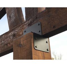 a close up of a wooden structure with metal brackets