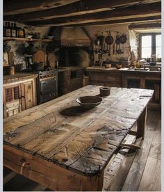 a rustic kitchen with an old wooden table