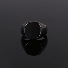 The Black Onyx Ring - Part of our new Blacked out collection. Created using real cuts of a black Onyx stone. Every stone is unique making it the perfect Ring for your unique style. This is our Latest Larger Signet Ring! Available in three different gemstones!  Available in Black / Silver / 18K Gold. Also available in Black Onyx (Real stone) & Green Opal (Lab Created) & Lapis Lazuli (Royal Blue) Unisex ring, womens sizes available.  DETAILS  Materials: Stainless Steel (Base) & 18K Gold PVD Platin Modern Black Round Rings, Modern Black Adjustable Rings, Minimalist Black Rings For Formal Occasions, Classic Black Adjustable Signet Ring, Black Minimalist Signet Ring For Formal Events, Black Minimalist Signet Ring For Formal Occasions, Elegant Black Stainless Steel Rings, Black Minimalist Formal Signet Ring, Modern Black Enamel Signet Ring