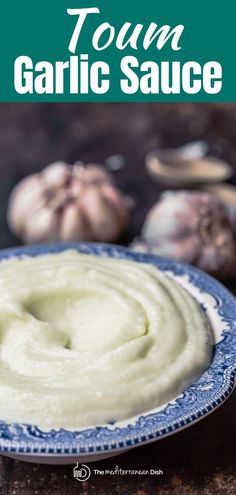 a bowl filled with garlic sauce on top of a table