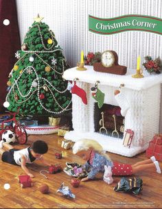 there are many toys on the floor in front of a christmas tree and fire place