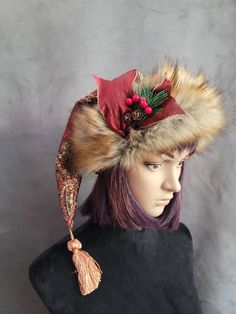 SIZING  The short hats fit average heads of 22 to 23 inches and have a fur pom pom, and the mid-length hats fit 23 to 24 inch heads and all have tassels for the pom.     These hats are made from a gorgeous rich cranberry brocade fabric. It has gold and black stitching throughout it with a big bold pattern. The patterns will vary from hat to hat, and these hats are not lined.     The short hats have a fur pom pom that matches the brim. The brims are cut generously and need to be cuffed down so th Adjustable Winter Hat With Feather Trim, Adjustable Winter Hats For Costume Events, Winter Festival Top Hat With Short Brim, Adjustable Hats For Winter Costume, Winter Festival Beanie Mini Hat, Winter Festival Top Hat With Curved Brim, Adjustable Christmas Costume Hats, Winter Hat With Feather Trim, Whimsical Winter Mini Hats For Costumes