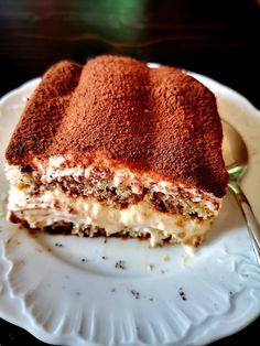 a piece of cake sitting on top of a white plate with a fork in it