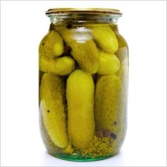 pickled cucumbers in a glass jar on white background