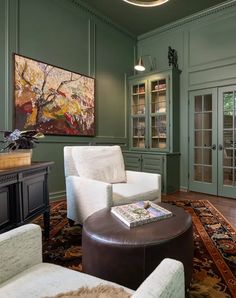 a living room filled with furniture and green walls