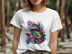 🌺🐍 Step out in vibrant style with this Tropical Snake and Floral Print T-Shirt. Perfect for anyone who loves to make a statement with their wardrobe, this colorful tee features a striking design of an exotic snake intertwined with lush, tropical flowers and leaves. Made with comfort in mind, it's ideal for everyday wear or as a unique gift for the nature enthusiast in your life. Embrace your wild side and add a pop of botanical beauty to your outfit! 🌿🌸 Product Features: Fabrication: Medium fabric (5.3 oz/yd² (180 g/m 100% cotton (fiber content may vary for different colors) Seams: Without side seams Fit: Classic Fit Sizing: Family Sizing Label: Tear-away label Colorful Tropical Print Casual Tops, Colorful Casual Tops With Tropical Print, Graphic Tee With Tropical Print For Spring, Casual T-shirt With Vibrant Print, Tropical Multicolor Crew Neck Top, Casual T-shirt With Vibrant Print And Short Sleeves, Spring Graphic Tee With Tropical Print, Tropical Multicolor T-shirt For Vacation, Casual Short Sleeve T-shirt With Vibrant Print