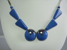 "From the Art Deco era, here's a blue glass bead necklace with mercury glass tube bead side chains.  The two round center beads are accented with silver paint and the entire piece measures 17\" long and has a fish hook style clasp.  Including some earrings that probably did not originally go with the necklace, but the colors are good together. Please see the picture with a coin for size comparison, as items may appear larger than they actually are.  This is necessary to provide accurate details. Blue Beaded Retro Jewelry, Retro Blue Beaded Jewelry, Modern Blue Metal Necklaces, Modern Blue Metal Necklace, Vintage Blue Necklace With Silver Beads, Blue Metal Beaded Necklace With Round Beads, Vintage Blue Necklaces With Polished Beads, Vintage Blue Round Beaded Necklace, Vintage Blue Beaded Necklace