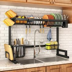 a kitchen sink with dishes and utensils hanging from the rack on the wall