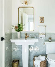 a bathroom with a sink, toilet and mirror in it's centerpieces