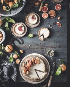 a table topped with pies and fruit on top of it