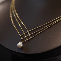 The 18K Gold Plated White Pearl Pendant Necklace for Women is a stunning and elegant piece of jewelry that exudes timeless beauty and sophistication. This necklace features a lustrous white pearl as its focal point, surrounded by a delicate and intricately designed 18K gold-plated pendant setting. This delicate pearl pendant necklace make for an elegant addition to any outfit. Classic jewelry vibe combined with the fashion-forward trend. Comfortable for daily wear, suitable for every occasion. Perfect Gift: This necklace will be a special gift for friends, wife, daughter, mother, sister, perfect gift for Christmas, Graduation, Birthday, Thanksgiving day, Valentine's Day Anniversary, Graduated Day, Mother's day. Material: Brass/18K Gold Plated/Pearl Size：23.0"+2.0"Extension Chain Color: Gol Elegant Gold Plated Round Pearl Necklace, Elegant Pearl Necklace As Gift, Elegant Gold Pearl Chain Necklace, Elegant Pearl Necklace Gift, Elegant Pearl Necklace For Gift, Elegant Gold-plated Round Pearl Necklace, Gold Refined Pearl Necklace, Elegant White Gold Plated Pearl Necklace, Refined Gold Pearl Necklace