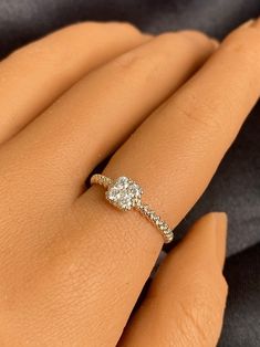 a woman's hand with a diamond ring on it