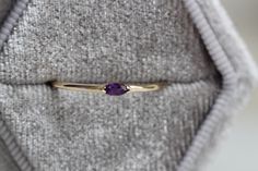 "A dainty marquise amethyst is at the center of our \"Wink\" ring, giving you just a little wink of sparkle! - Marquise stone measures 4mm x 2mm - Handcrafted out of 14K yellow, rose, or white gold - Round band measures 1.2mm in width Processing Times - Current processing time is 1 - 3 weeks. Each Item is handmade to order with love and care! In Stock Items - Contact Liesel Love with any rush order questions, or to see if we have anything ready made and in stock. Returns - Liesel Love does take Marquise Gemstone Stackable Promise Rings, Marquise Amethyst Ring Gemstone Gift, Marquise Amethyst Ring Gift, Marquise Amethyst Ring As Gift, Gift Marquise Amethyst Ring, Gold Marquise Amethyst Ring, Heirloom Marquise Birthstone Ring As Gift, Marquise Gemstone Stackable Rings Gift, Marquise Gemstone Stackable Rings For Anniversary