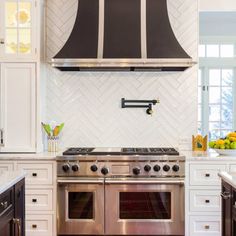 a stove top oven sitting inside of a kitchen next to an oven and countertop