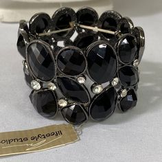 This Beautiful Stretch Bracelet Is Full Of Different Sizes And Shapes Of Black Faceted Stones With Clear Rhinestones Scattered Throughout The Bracelet. New And Never Worn. See Pictures For Details Ask Any Questions Bundle For Extra Savings Happy Poshing Black Crystal Jewelry With Jeweled Details, Black Crystal Jeweled Jewelry, Black Jeweled Crystal Jewelry, Silver Crystal Bracelet With Stones For Party, Silver Bracelets With Stones For Party, Silver Bracelet With Stones For Party, Silver Party Bracelet With Stones, Black Stone Jewelry For Party, Metal Crystal Bracelet With Stones For Party