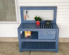 a blue shelf with some plants on it and a potted plant next to it