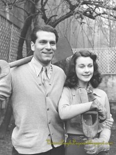 an old black and white photo of a man holding a baseball bat next to a woman