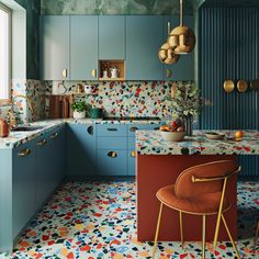 a kitchen with blue cabinets and colorful floor tiles on the walls, along with a bar stool