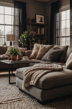 a living room filled with lots of furniture and pillows on top of a rug covered floor