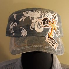 a hat with a cross on it sitting on top of a mannequin's head