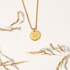 Looking for a special piece of jewelry that's both elegant and personalized? Look no further than this beautiful initial coin necklace that's customized with your chosen initial! PREMIUM MATERIAL -- Made from premium stainless steel and 14K Gold, and designed to last. This necklace is both tarnish-resistant and hypoallergenic, so it's perfect for sensitive skin. PERSONALIZED TAG -- Perfect for anyone who loves to express their individuality through their accessories.  Note: If a font is not given, you will receive the font that is pictured for your order which is font #1. FANCY DESIGN --  Designed for creating a truly fancy and one-of-a-kind piece. Engraved into coin pendants and creates a classy high-class look impression, which is perfect to wear every day on any occasion. PERFECT FOR HE Classic Yellow Gold Initial Necklace For Anniversary, Classic Initials Name Necklace For Anniversary, Classic White Gold Charm Necklace With Initials, White Gold Tarnish Resistant Initial Pendant Necklace, Tarnish Resistant White Gold Initial Pendant Necklace, Tarnish-resistant White Gold Initial Pendant Necklace, Classic Round 14k Gold Name Necklace, Classic Initial Pendant Charm Necklace For Anniversary, Gold Initial Necklace With Monogram