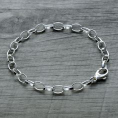 "Trust us your wrist needs our dainty classic sterling silver rolo link charm bracelet in 925 sterling silver. It's made in Italy and an absolutely stunning piece. So shiny and classy! Elevates your everyday outfits and will become a go-to jewelry piece since it matches with e-v-e-r-y-t-h-i-n-g! This petite bracelet is a perfect gift for a girl or teenager. It's also great for layering. Offered in 925 sterling silver, 18k rose gold vermeil and 18k yellow gold vermeil. All finishes use solid 925 sterling silver as base material. The vermeil gold finish is 5 times thicker than regular gold plating and is the best quality jewelry other than solid gold - a perfect combination of quality and value. Features: - Sterling silver rolo chain - Made in Italy - Bracelet weight is 4.9grams for 7.5\" le Nickel-free Sterling Silver Oval Link Bracelet, Classic Silver Chain Charm Bracelet With Oval Links, Silver Charm Bracelet With Rolo Chain For Gift, Sterling Silver Rolo Chain Bracelet For Everyday, Everyday Charm Bracelet With Rolo Chain, Silver Minimalist Oval Link Charm Bracelet, Minimalist Silver Oval Link Charm Bracelet, Everyday Silver Charm Bracelet With Oval Links, White Gold Oval Link Charm Bracelet With Lobster Clasp