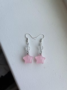 These are cute, handmade pink star earrings. Handmade Pink Crystal Drop Earrings, Casual Pink Earrings, Cute Star Charm Dangle Earrings, Pink Star Earrings For Party, Cute Dangle Earrings With Star Charm, Pink Star-shaped Party Earrings, Star-shaped Crystal Earrings For Gifts, Handmade Casual Pink Earrings, Single Star-shaped Crystal Earring As Gift