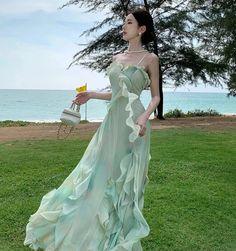 Indulge in ethereal elegance with the Oceana Dress. The flowy, waterfall design embodies the whimsical spirit of fairycore fashion aesthetic. Perfect for romantic picnics at the beach or enchanting garden parties, this dress will make you feel like a fairy princess. Don't just dream, live your fairytale now! Size S bust 80cm waist 68cm length 137cm Size M bust 84cm waist 72cm length 137cm Size L bust 88cm waist 76cm length 137cm Causal Fairy Outfits, Long Fairycore Dress, Fairy Core Bridesmaid Dresses, Siren Aesthetic Dress, Flowy Mermaid Dress, Flowy Fantasy Dresses, Ethereal Formal Dress, Aphrodite Aesthetic Clothes, Siren Core Clothes