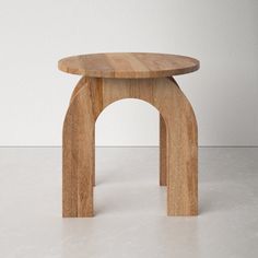 a wooden stool sitting on top of a white floor