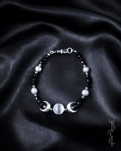 In honour of Artemis, Goddess of the wilds and Goddess of the moon. She who wears the crescent moon crown. An enchanting beaded bracelet featuring a Selenite sphere framed by crescent moons, and strung between black Onyx and silver freshwater pearls. This bracelet depicts the Triple Goddess symbol, the Selenite bead in the centre symbolising the full moon with a waxing and waning crescent on either side.  The crescent moon beads are produced in sterling silver and are uniquely textured by hand g Spiritual Moon Phase Bracelet Jewelry, Spiritual Moon Phase Bracelet, Bohemian Moon Phase Bracelet, Celestial Moon Phase Bracelet, Mystical Adjustable Moon Phase Jewelry, Adjustable Mystical Moon Phase Jewelry, Silver Spiritual Bracelets With Moon Phase, Celestial Crescent Bracelets With Moon Charm, Spiritual Moon Phase Round Bracelets