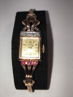 "14 Kt rose gold ladies wristwatch features diamonds and rubies with a different style lug on each side. This art deco fashion watch features a matching 14 kt rose gold snake style band that is a little over 6.5\", it will fit a 6.25\" and smaller wrist comfortably. The mechanical 17 jewel movement runs great and makes this beautiful timepiece ready to wind and wear. Truly a unique way to wear the time that is fashionable as well as functional." Elegant Pink Gold Watch For Formal Occasions, Pink Diamond Watch With Round Dial For Formal Events, Classic Pink Diamond Watch For Formal Occasions, Pink Diamond Watch With Round Dial For Formal Occasions, Rose Gold Diamond Watch With Round Dial For Evening, Art Deco Gold Diamond Watch Gift, Art Deco Diamond Watches With Diamond Accents, Formal Rose Gold Watches With Jubilee Bracelet, Formal Pink Diamond Watch With Diamond Hour Markers