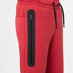 red sweat pants with black zippers on the side and an open pocket at the bottom