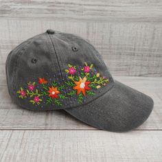 This beautiful women's baseball cap is hand embroidered with a bright floral pattern. It is a lovely piece to complete your everyday outfit or festive occasion wardrobe. The hand-stitched hat with wildflowers is a perfect gift for anyone who loves unique accessories. 💚 CAP DETAILS  *Color: gray(Charcoal). You can also choose other available colors from the variation list.  *One size fits most adults: head circumference is 22" - 28" (55 - 67 cm). *Fabric: 100% soft cotton twill, garment-washed, Embroidered Cotton Hat As Gift, Curved Brim Hats For Spring Gift, Curved Brim Hats For Spring Gifts, Spring Festival Embroidered Hat, Handmade Hats As Spring Gifts, Curved Brim Hat For Spring, Whimsical Spring Hats For Gifts, Whimsical Spring Hats For Gift, Whimsical Spring Hats As Gifts