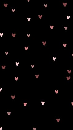 pink and black hearts are arranged in the shape of heart shapes on a black background