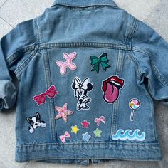 a denim jacket with various patches on it