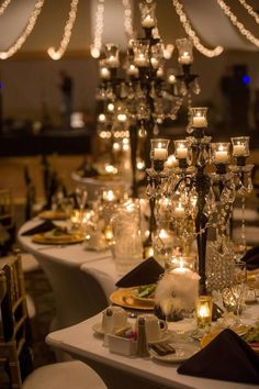 a long table with candles and plates on it is set up for a formal function