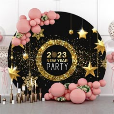 new year party decorations with balloons, streamers and stars on the wall behind it