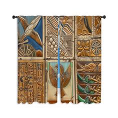 an image of decorative wall hangings made out of wooden blocks with birds and egyptian symbols on them