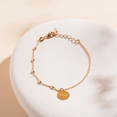 Our Personalized Mixed Beaded &amp; Chain Pastille Bracelet adds a simple yet elegant touch to your everyday jewellery collection. The delicate bracelet features a combination of two classic Merci Maman chains and a smooth disc, lovingly hand-engraved with your special names and dates.18K Champagne Gold PlatedBracelet measures 18cm, adjustable to 15cmPastille Charm: 1 x 1 cmEngraved by hand in our Paris workshopSent with love in a complimentary gift boxAny slight variations in lettering dept Everyday Chain Bracelet With Round Beads, Minimalist Chain Bracelet With Round Beads And Adjustable Chain, Minimalist Adjustable Chain Bracelet With Round Beads, Dainty Chain Bracelet With Adjustable Round Beads, Minimalist Satellite Chain Bracelet With Round Beads, Classic Adjustable Satellite Chain Bracelet, Minimalist Beaded Chain Bracelet, Adjustable Rose Gold Bracelet With Satellite Chain, Dainty Round Bracelets With Extender