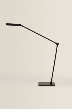 a black desk lamp sitting on top of a table