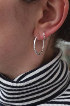 Absolute classics, the medium 2.5cm hammered hoop earrings. Made from substantial 2mm recycled silver wire they are hammered to perfection to catch the light. With a comfortable rounded end behind the earlobe. They are fitted with posts and butterflies to make them easy to wear.  They measure approx 2.5cm across and look fab with my little hammered huggies in the same style. My whole range works beautifully together for the dream stack.  Packaged in beautiful reusable and recycled packaging ready to give. Small Silver Hoop Earrings, Handmade Hoop Earrings, Sweet Earrings, Hammered Hoop Earrings, Sterling Silver Hoop Earrings, Recycled Silver, Hammered Silver, Hoop Earrings Small, Sterling Silver Hoops