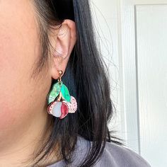 These earrings capture the essence of summertime and bring a touch of paradise to your ensemble. The vibrant colors and intricate details make these earrings truly stand out, adding a pop of color and fun to any outfit! Length: 1.75 inches Each design of earrings is unique and cannot be exactly replicated. Extremely light and comfortable to wear. Slight variation may occur compared to the pictures as they are handmade items. All earrings are made of acrylic with gold-plated stainless steel posts Colorful Vibrant Earrings With Ear Wire, Vibrant Drop Earrings Jewelry Gift, Vibrant Drop Earrings For Gifts, Artsy Summer Earrings With Ear Wire, Vibrant Green Dangle Earrings, Vibrant Drop Earrings For Gift, Colorful Hand Painted Drop Earrings, Colorful Hand-painted Drop Earrings, Multicolor Dangle Flower Earrings For Summer