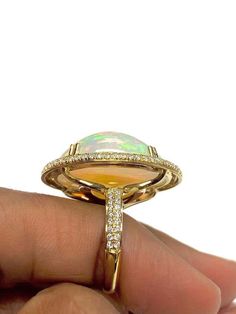 For Sale on 1stDibs - White Opal Cabochon Ring With Diamond in 18K Yellow Gold, from 'G-One' Collection Stone size: 24 X 19 mm Gemstone Weight: 19.20 Carat Diamonds G-H / VS Luxury Diamond Gemstones With Cabochon Cut, Luxury Diamond Cabochon Gemstones, Luxury Oval Cabochon Diamond Gemstones, Luxury Yellow Gold Oval Cabochon Gemstones, Luxury Multi-stone Oval Cabochons, Yellow Gold Multi-stone Cabochons Fine Jewelry, Yellow Gold Multi-stone Cabochons For Fine Jewelry, Luxury Cabochon Diamond Ring For Formal Occasions, Luxury Formal Cabochon Diamond Ring