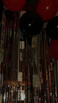 red and black balloons are hanging from the ceiling